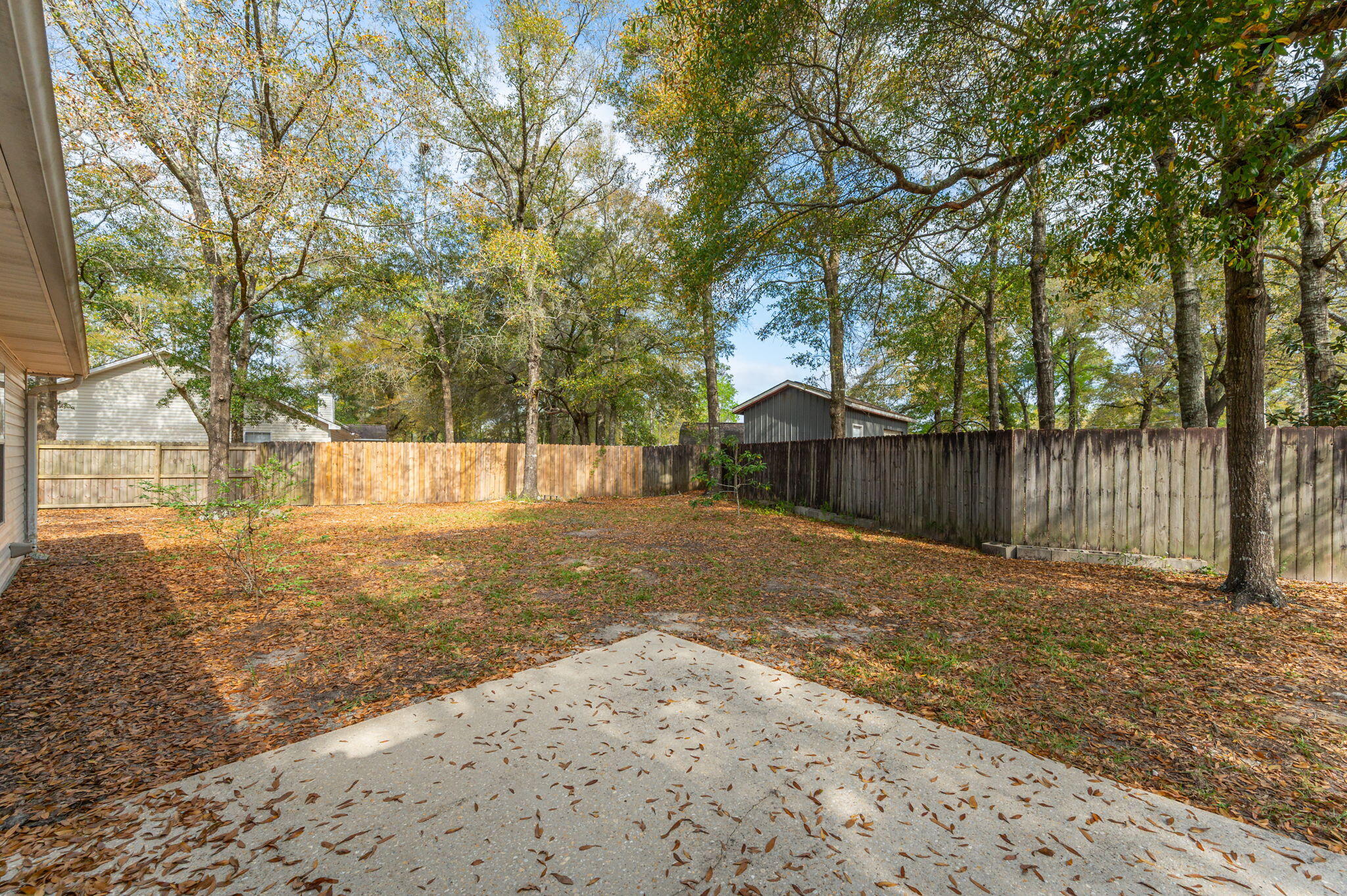 223 Runnymeade Drive Crestview, FL 32539 - Photo 33 of 38 a view of a yard with wooden fence and a large tree