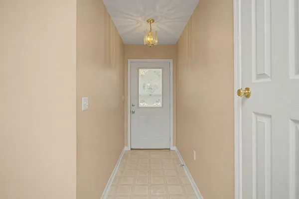 a view of a hallway with a chandelier