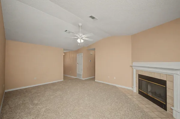 a view of an empty room with a fireplace