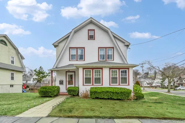 a front view of a house with a yard