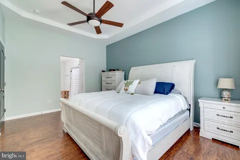 a bedroom with a large bed and a chandelier