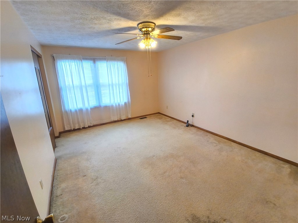 2672 Crackel Road Aurora, OH 44202 - Photo 34 of 38 Carpeted spare room featuring ceiling fan and a textured ceiling