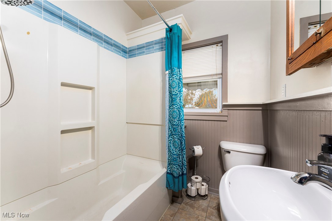 1507 Cherry Road Northwest Massillon, OH 44647 - Photo 17 of 28 Full bathroom featuring toilet, shower / bath combo with shower curtain, and sink