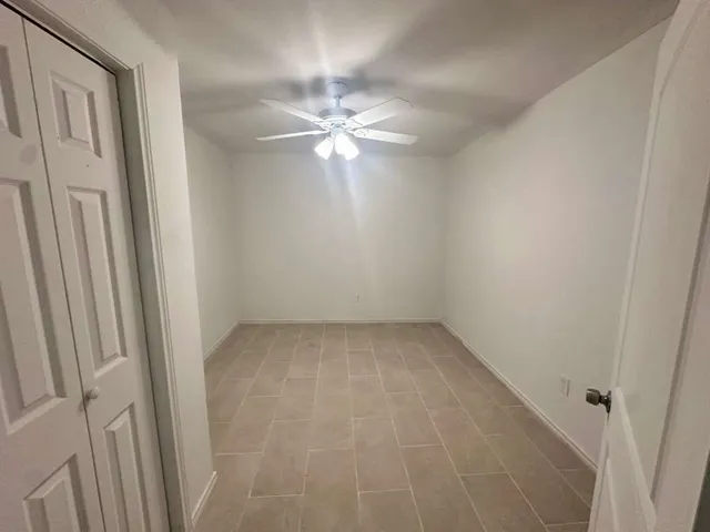 a view of room with window and ceiling fan