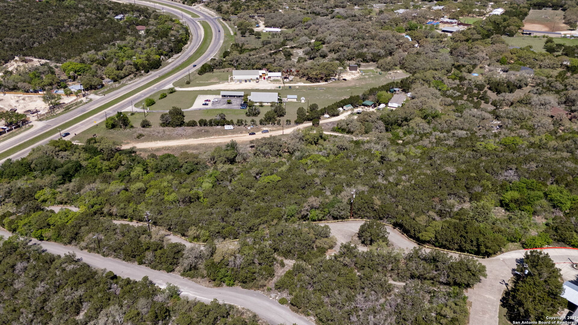 0 North State Highway 16 Helotes, TX 78023 - Photo 6 of 17 a view of a houses with a lush green forest