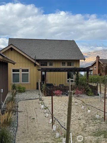 a patio with a table and chairs and potted plants
