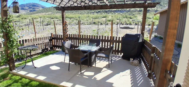 a view of a patio with a table and chairs