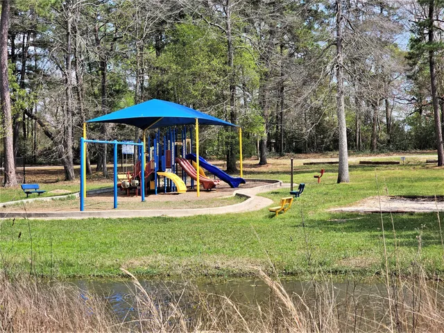 a view of a park with swings and slides