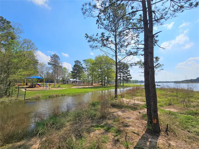 a view of swimming pool with a yard and lake view