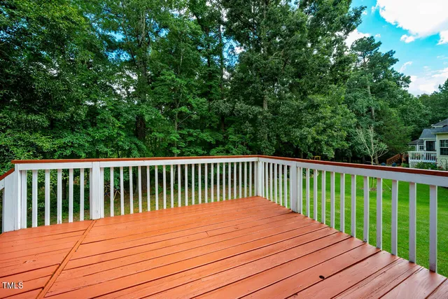 a view of balcony with wooden floor and fence