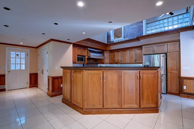 a kitchen with stainless steel appliances granite countertop a refrigerator and a stove