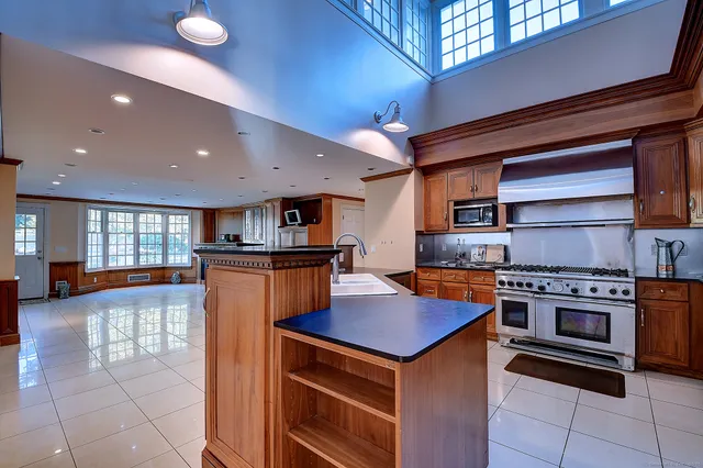 a kitchen with stainless steel appliances granite countertop a stove and a sink