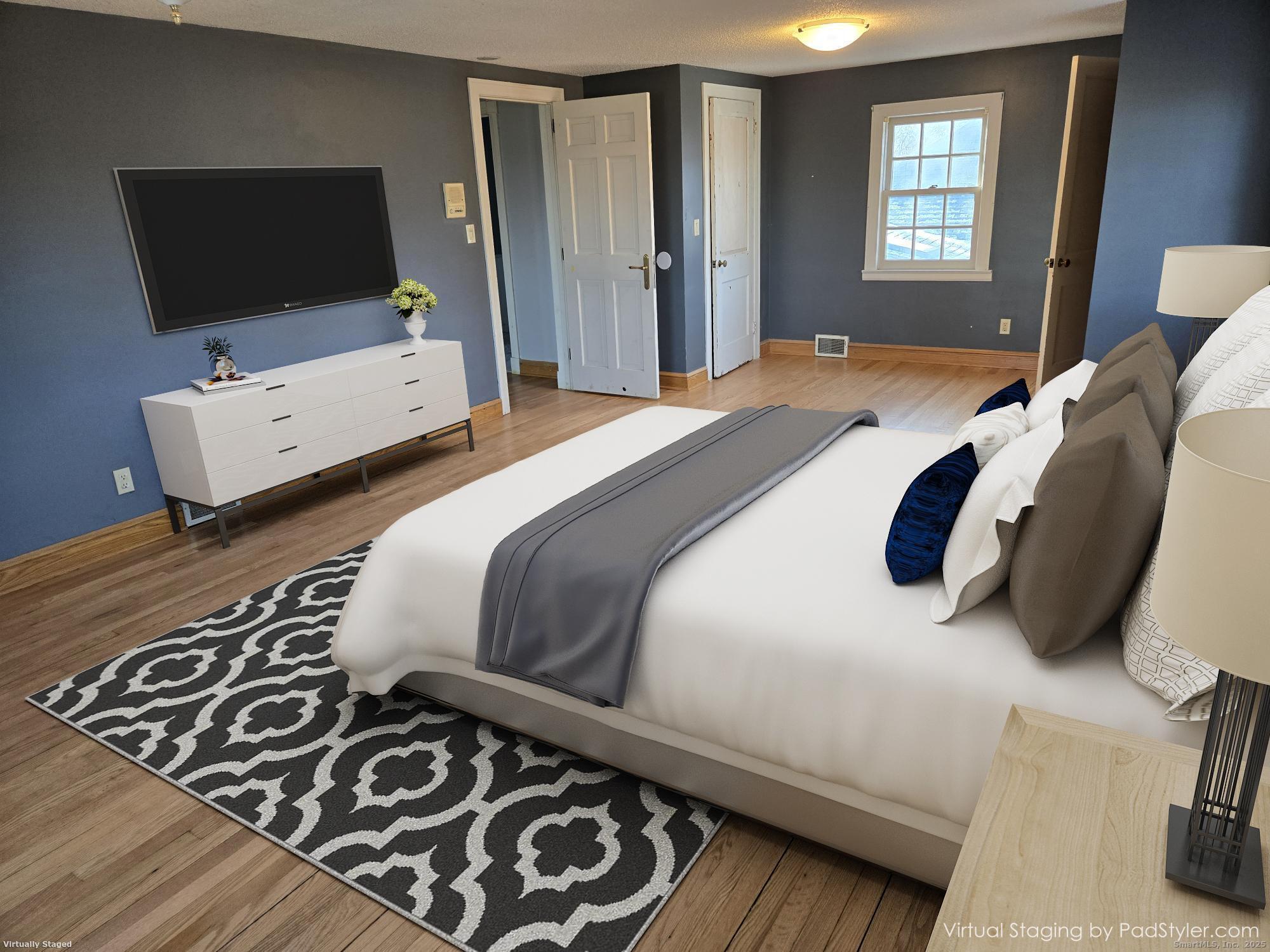 615 Ridge Road Wethersfield, CT 06109 - Photo 27 of 40 a bedroom with a bed and flat screen tv