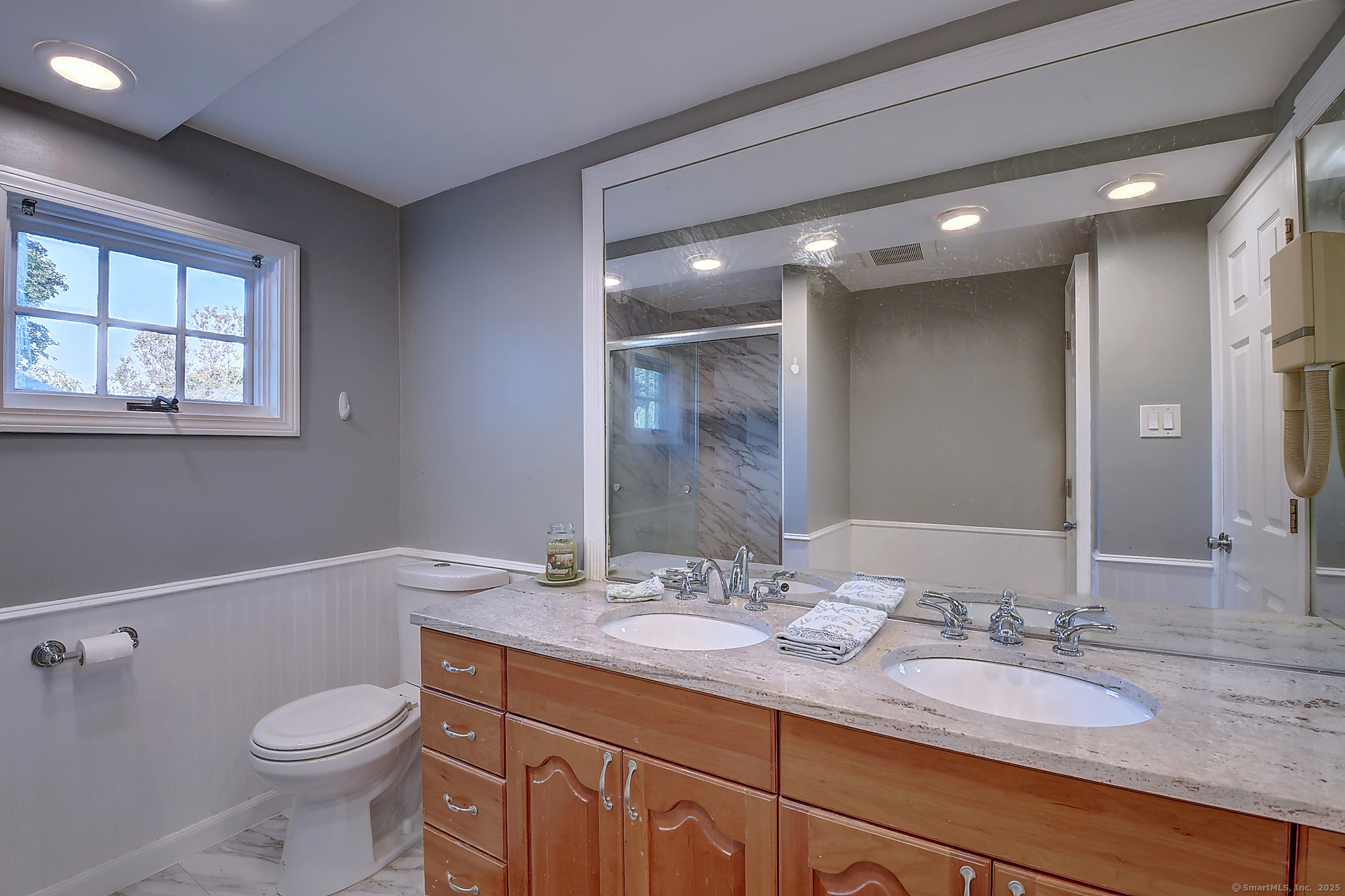 615 Ridge Road Wethersfield, CT 06109 - Photo 31 of 40 a bathroom with a granite countertop toilet sink and mirror