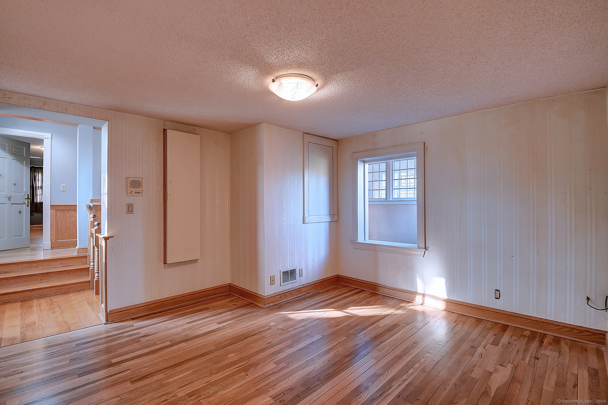 615 Ridge Road Wethersfield, CT 06109 - Photo 33 of 40 an empty room with wooden floor and windows