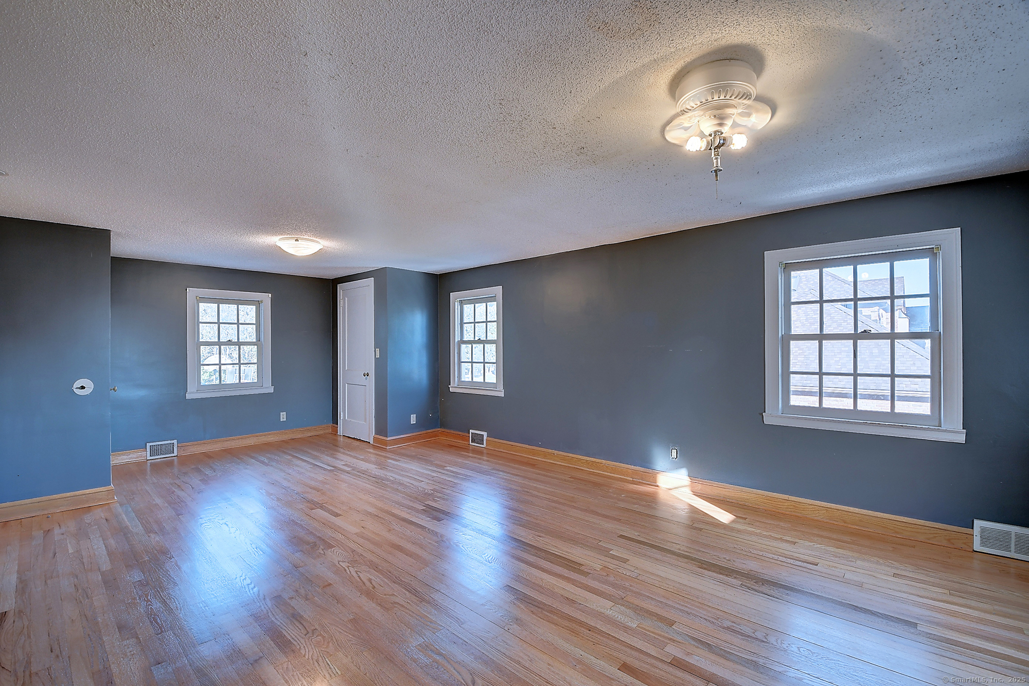615 Ridge Road Wethersfield, CT 06109 - Photo 35 of 40 a view of an empty room with a window and wooden floor