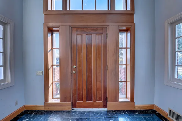 a view of front door with wooden floor