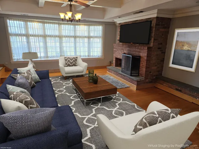 a living room with furniture a flat screen tv and a fireplace