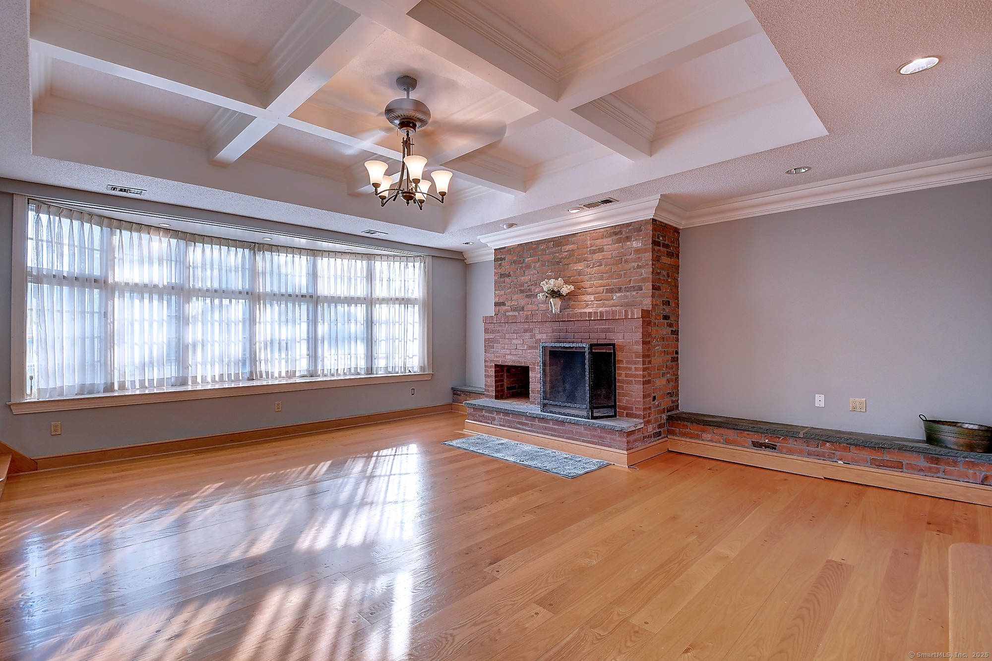 615 Ridge Road Wethersfield, CT 06109 - Photo 5 of 40 a view of an empty room with a fireplace and a window
