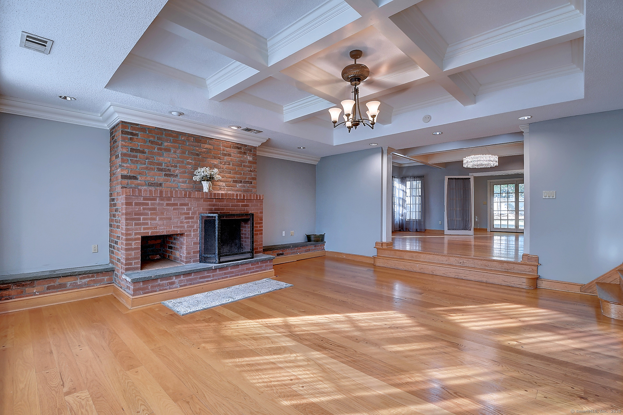 615 Ridge Road Wethersfield, CT 06109 - Photo 8 of 40 a view of an empty room with a fireplace and chandelier fan