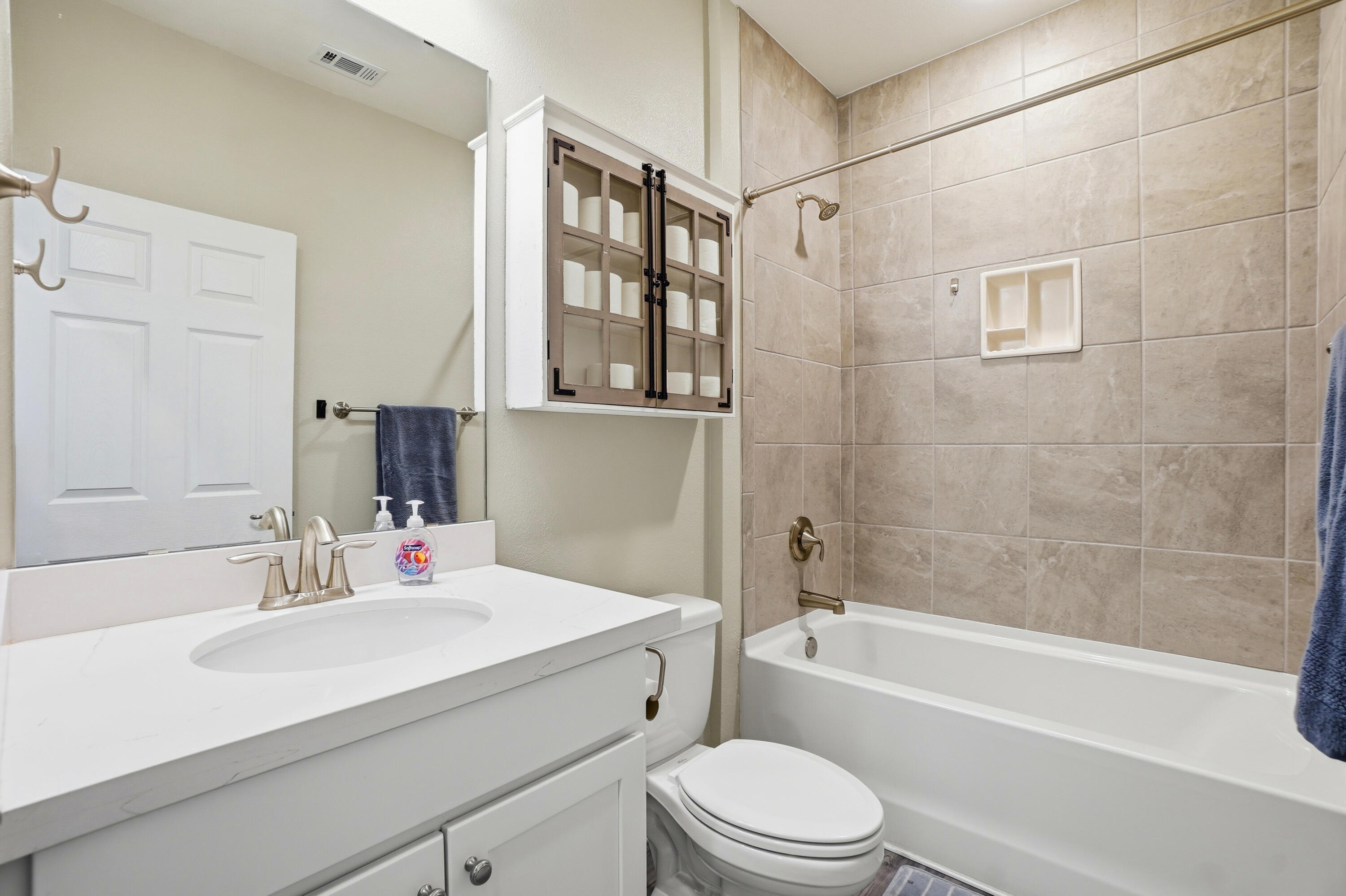 525 Windchime Way Freeport, FL 32439 - Photo 25 of 59 a bathroom with a sink a toilet a mirror a bathtub and shower