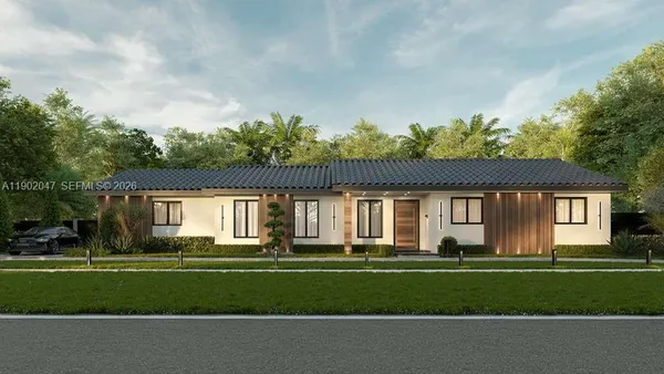 a front view of a house with a garden and trees