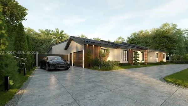 a view of a house with backyard and trees in the background