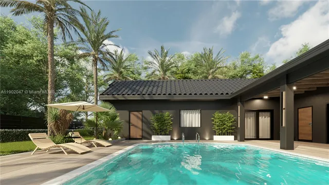 a view of a house with backyard and sitting area