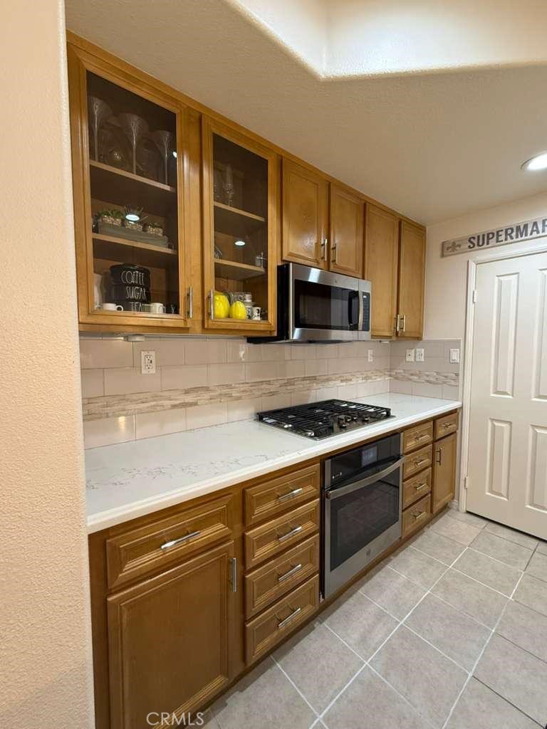 2931 Esperanza Way, Unit B Simi Valley, CA 93063 - Photo 14 of 49 a kitchen with granite countertop a stove and a refrigerator