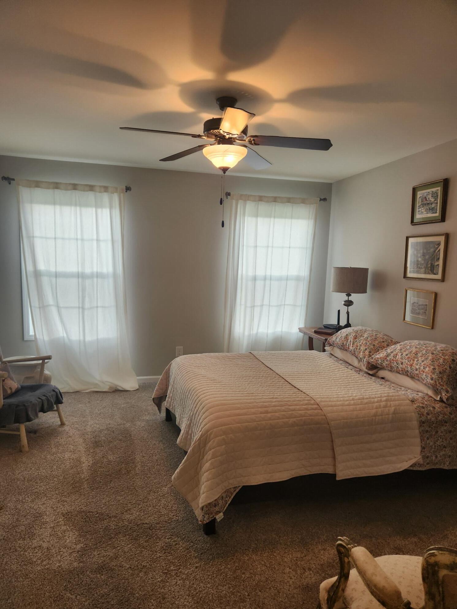 838 Daisy Circle Northeast De Motte, IN 46310 - Photo 23 of 41 a bedroom with a bed and a chandelier