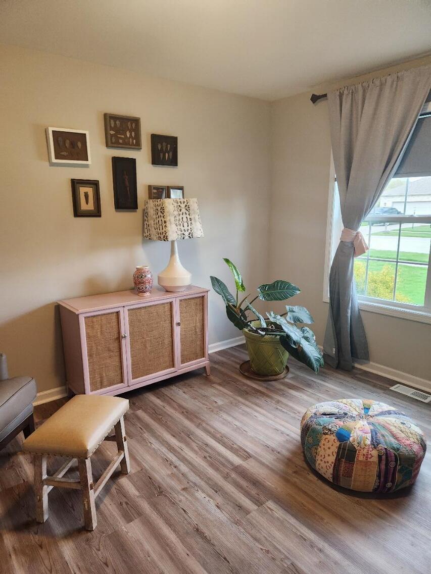 838 Daisy Circle Northeast De Motte, IN 46310 - Photo 29 of 41 a living room with furniture and a wooden floor