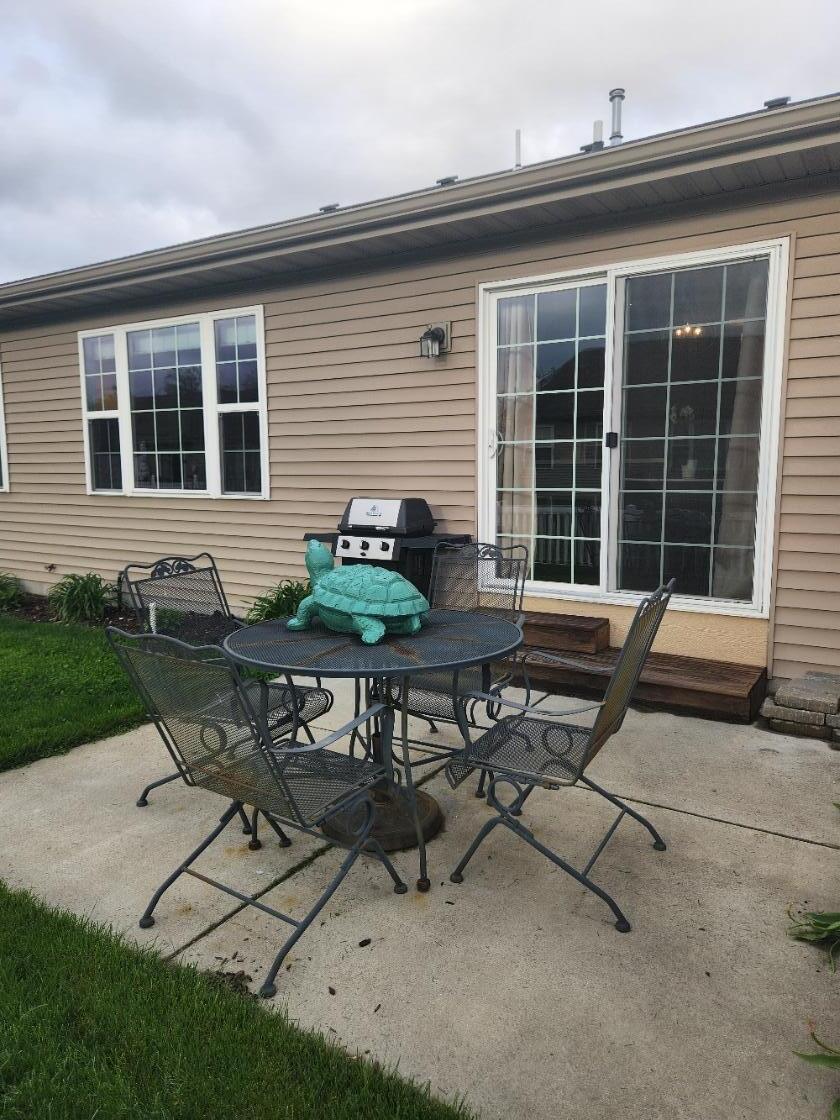 838 Daisy Circle Northeast De Motte, IN 46310 - Photo 39 of 41 a backyard of a house with table and chairs