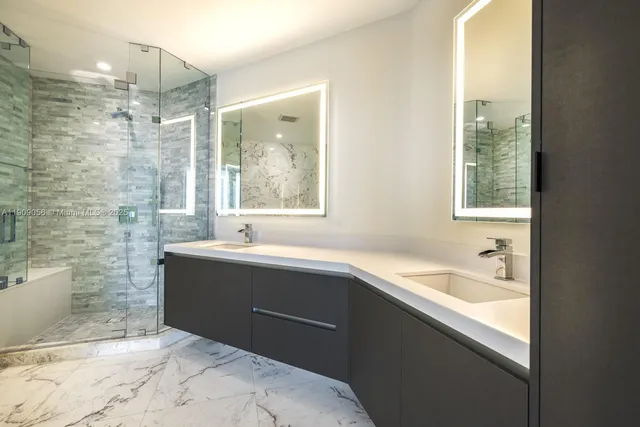 a bathroom with a bathtub sink and mirror
