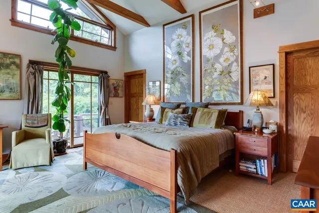 a bed sitting in a spacious bedroom next to a window