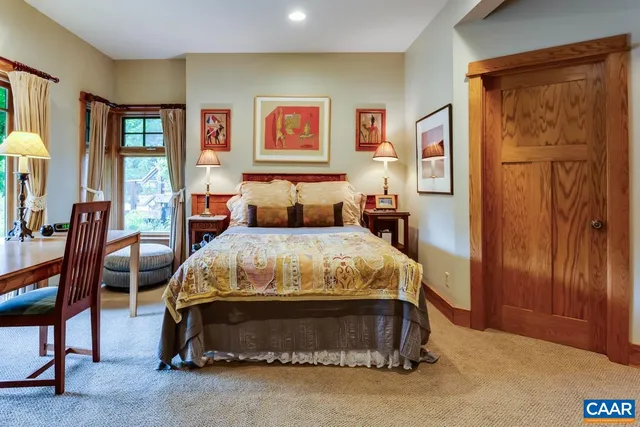 a bedroom with a bed next to a window