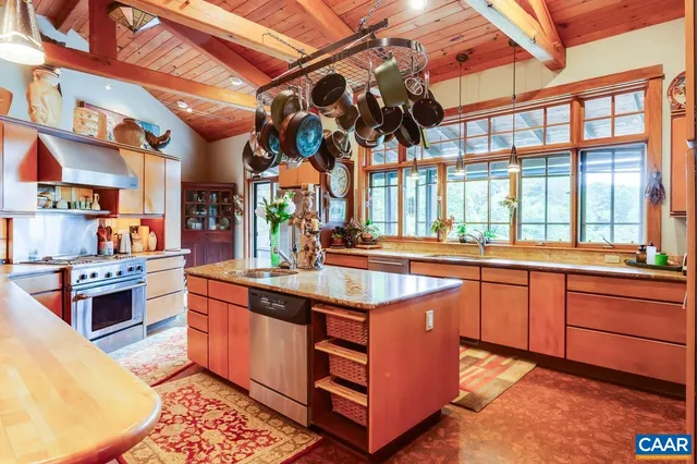 a view of a big room with dining area wooden floor and a fireplace