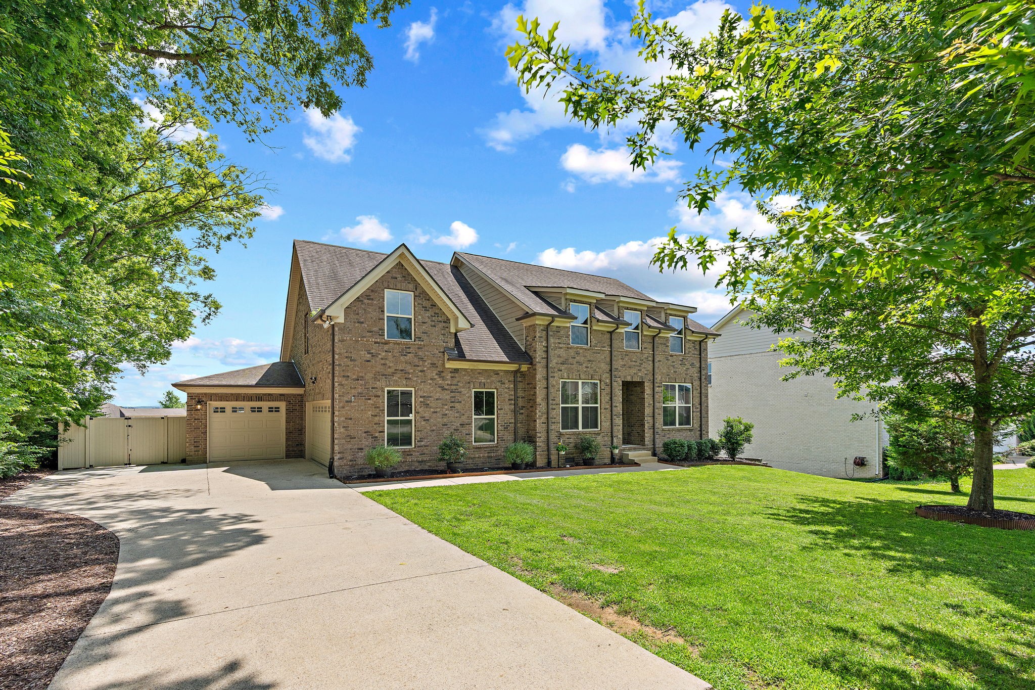 2957 Stewart Campbell Pointe Spring Hill, TN 37174 - Photo 1 of 53 a front view of a house with a garden and trees