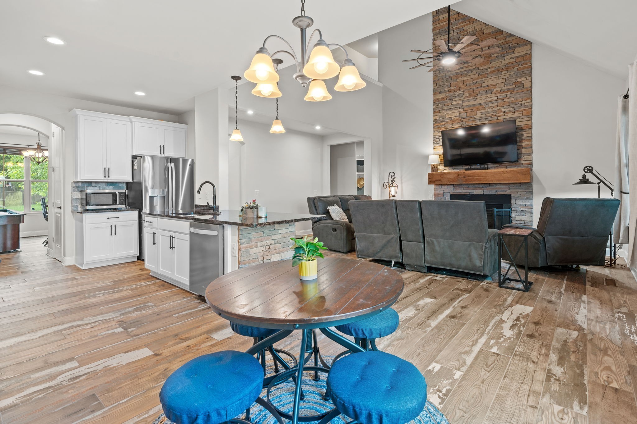 2957 Stewart Campbell Pointe Spring Hill, TN 37174 - Photo 11 of 53 a living room with kitchen island furniture and a chandelier