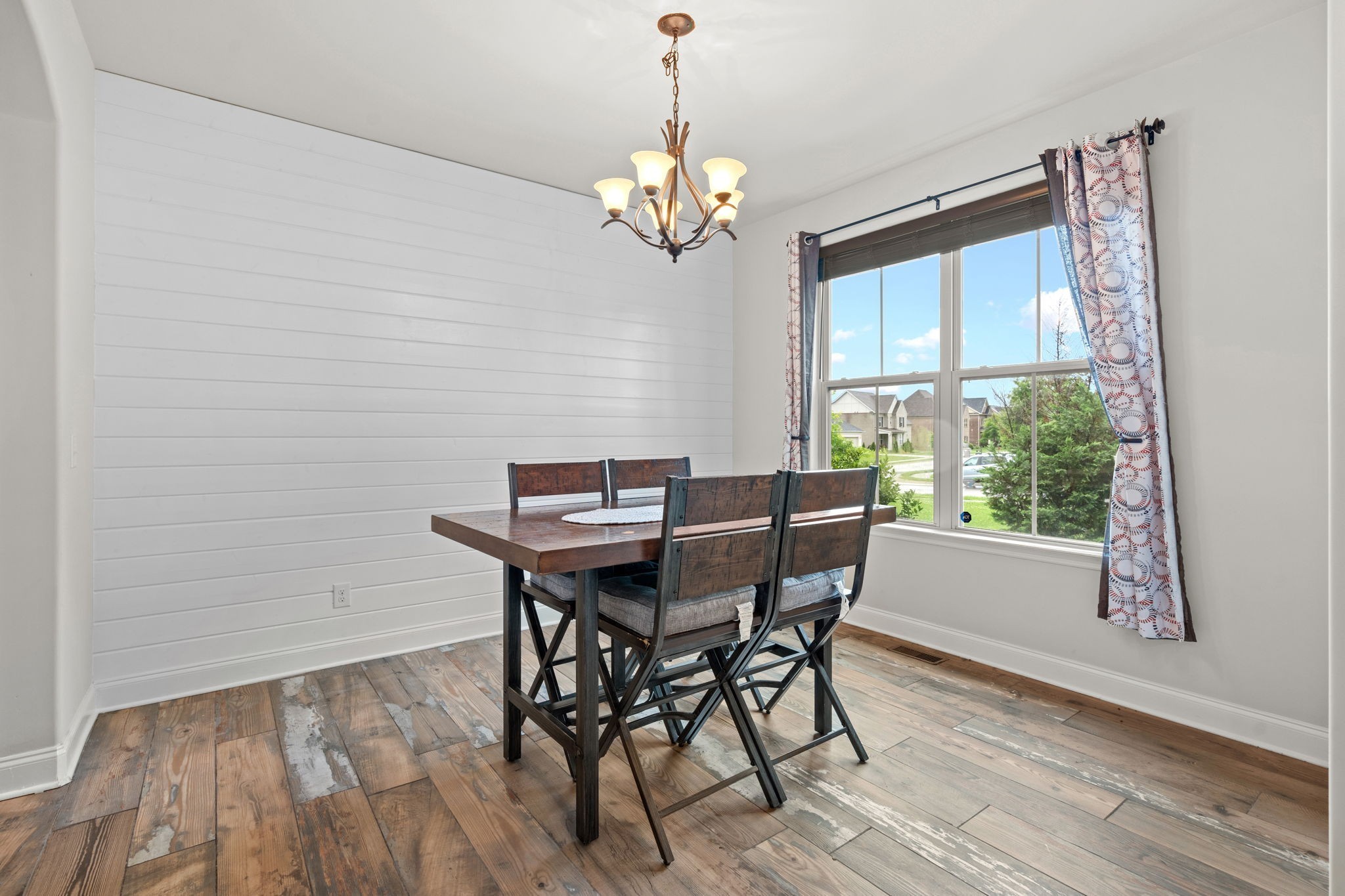 2957 Stewart Campbell Pointe Spring Hill, TN 37174 - Photo 15 of 53 a dining room with wooden floor a chandelier a wooden table and chairs