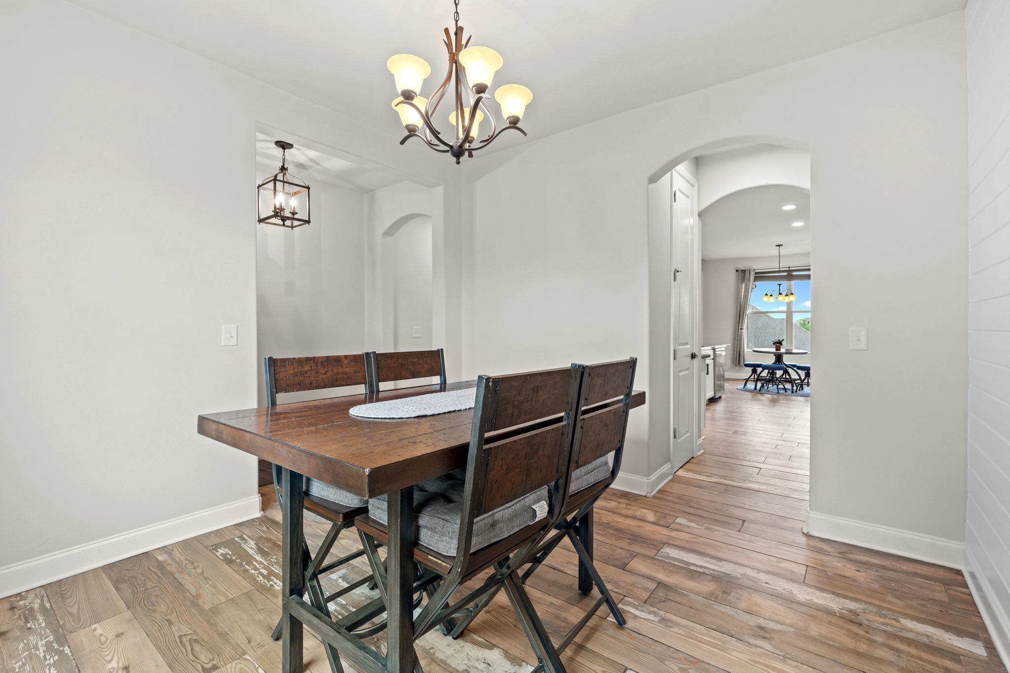 2957 Stewart Campbell Pointe Spring Hill, TN 37174 - Photo 16 of 53 a view of a dining room with furniture and wooden floor