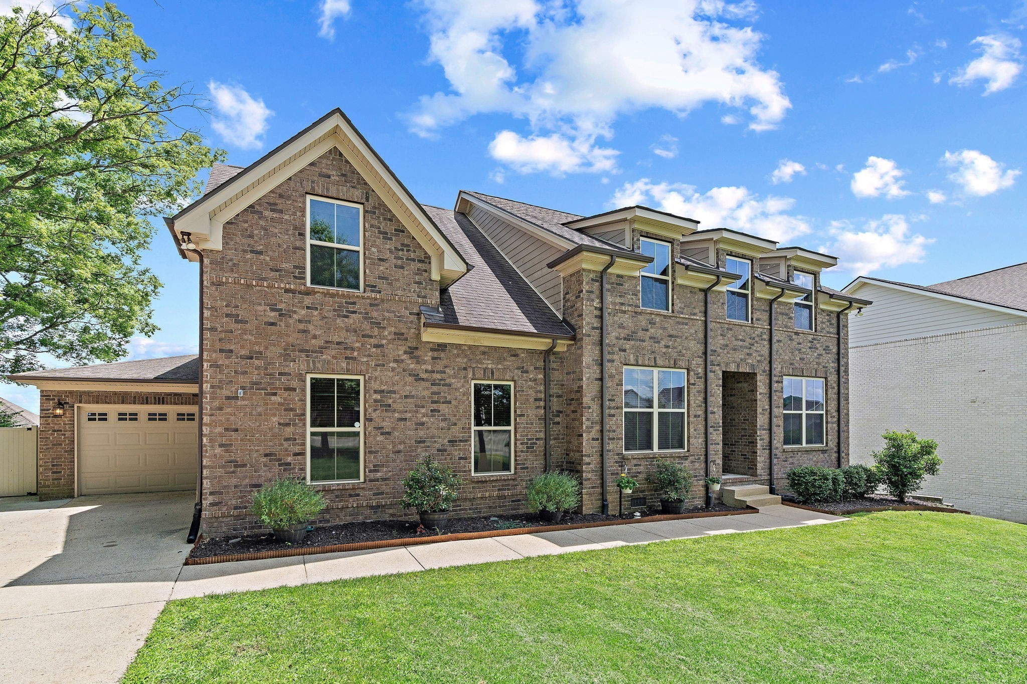 2957 Stewart Campbell Pointe Spring Hill, TN 37174 - Photo 4 of 53 a front view of a house with a yard and garage