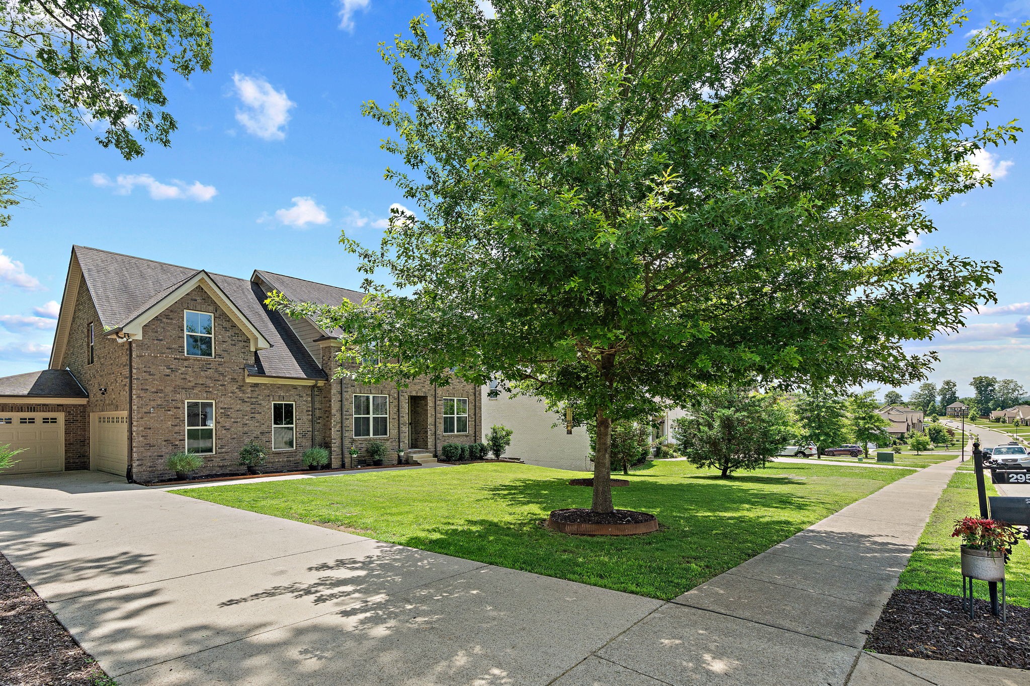 2957 Stewart Campbell Pointe Spring Hill, TN 37174 - Photo 7 of 53 a front view of a house with a yard and trees