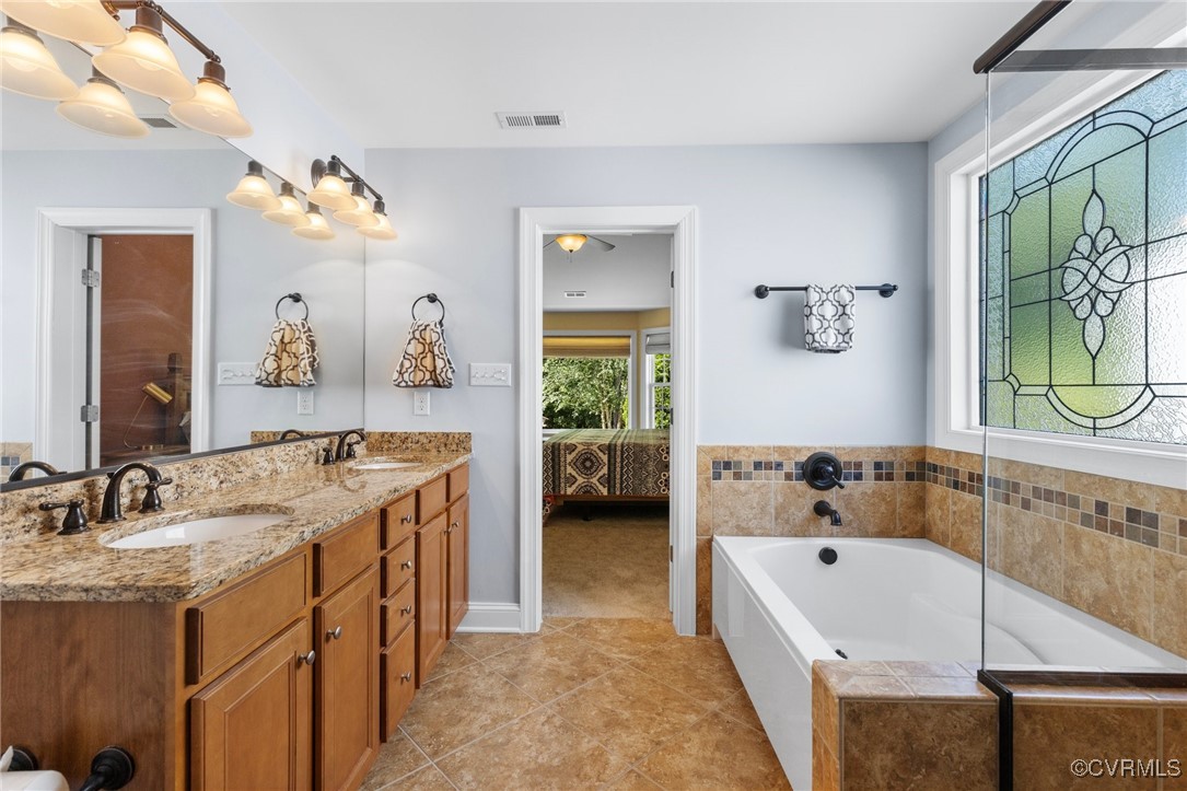 14619 Forest Row Trail Midlothian, VA 23112 - Photo 21 of 43 a spacious bathroom with a tub sink and mirror