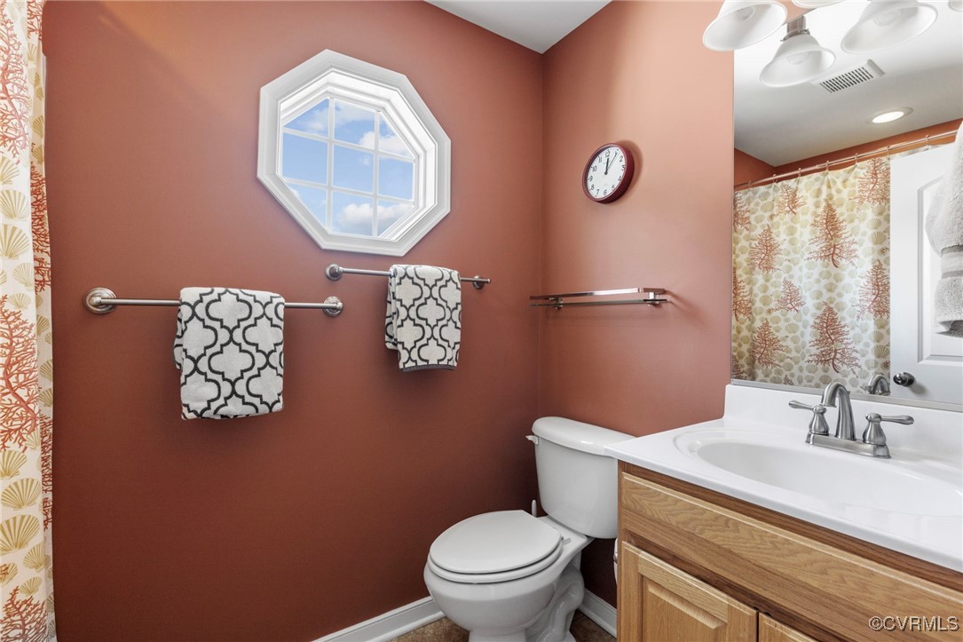 14619 Forest Row Trail Midlothian, VA 23112 - Photo 27 of 43 a bathroom with a toilet a sink and mirror