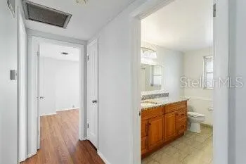 a bathroom with a sink a mirror and a toilet