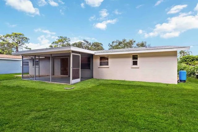 a view of a house with backyard porch and garden