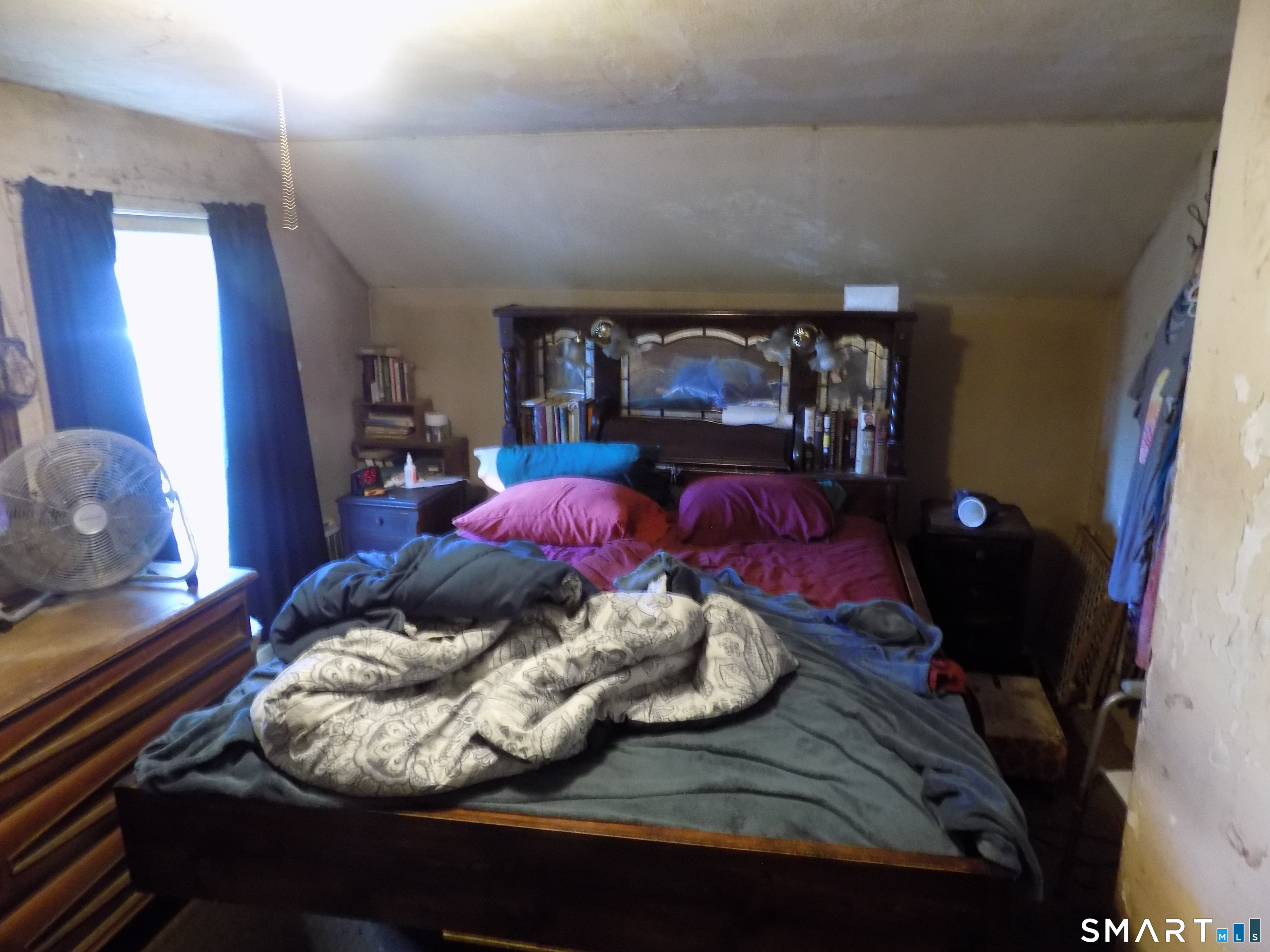 149 South Riverside Avenue Plymouth, CT 06781 - Photo 7 of 12 a bed sitting in a bedroom next to a window