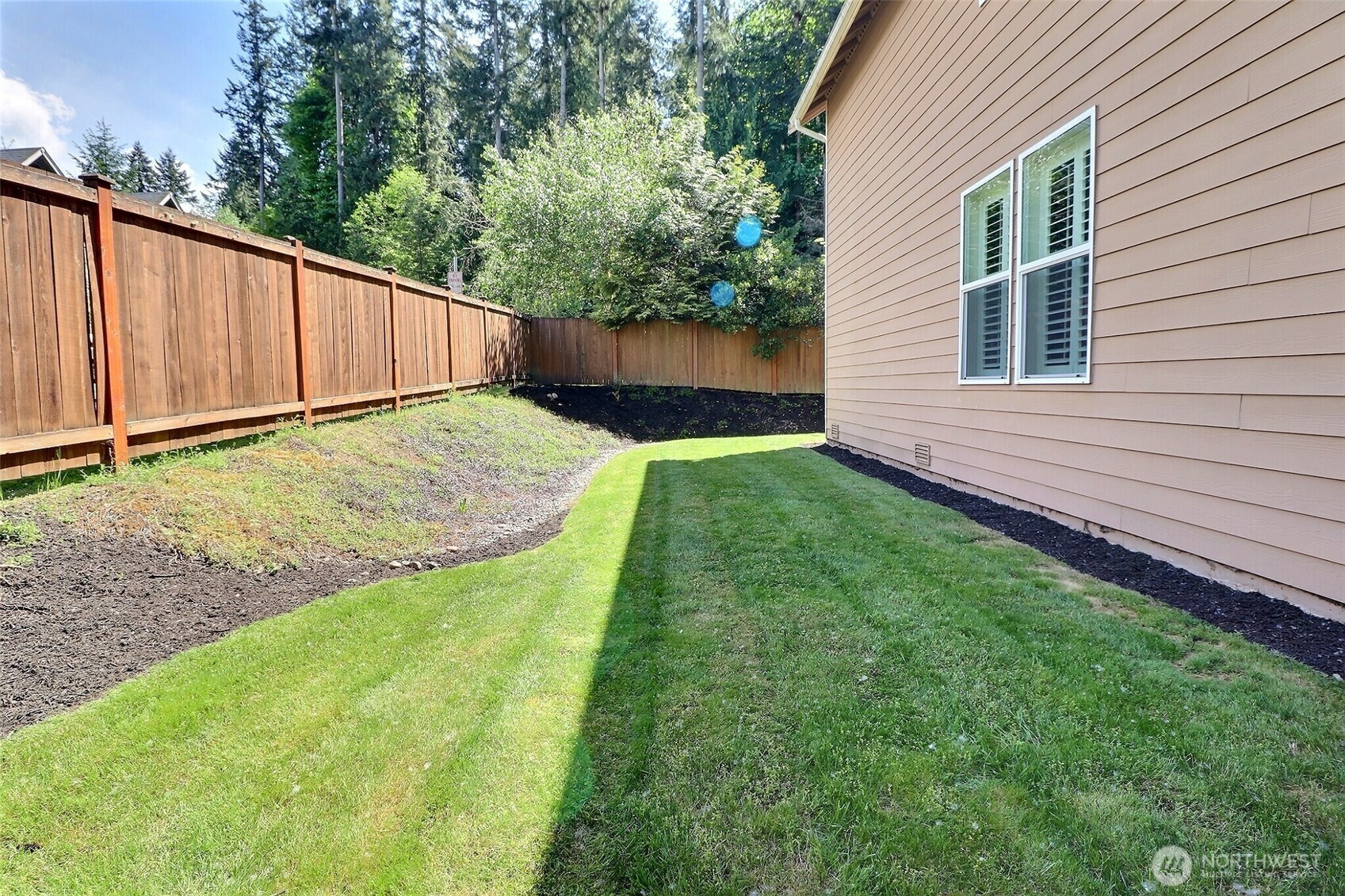 19776 Mountain Ridge Road Southeast Monroe, WA 98272 - Photo 35 of 40 a view of a backyard with wooden fence