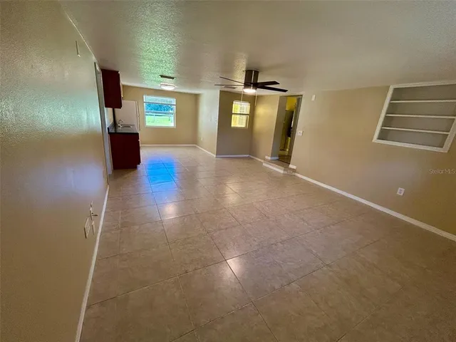 a view of hallway with stairs and wooden floor