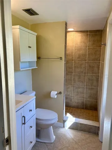 a bathroom with a shower and a toilet